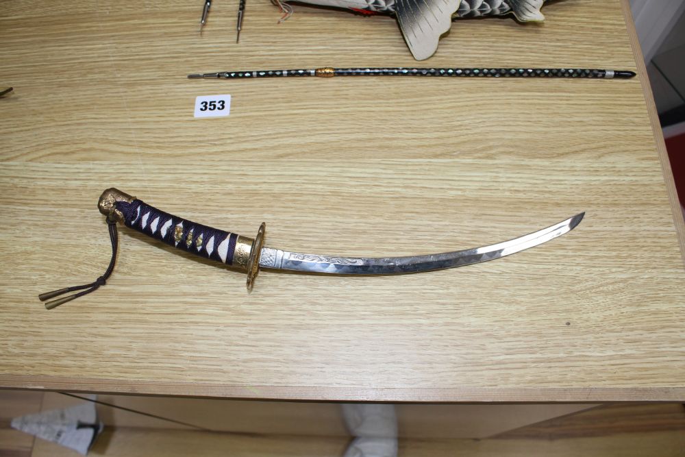 A Japanese late Meiji period set of lacquered model weapons on display stands, comprising archers bow, samurai sword and other weapons